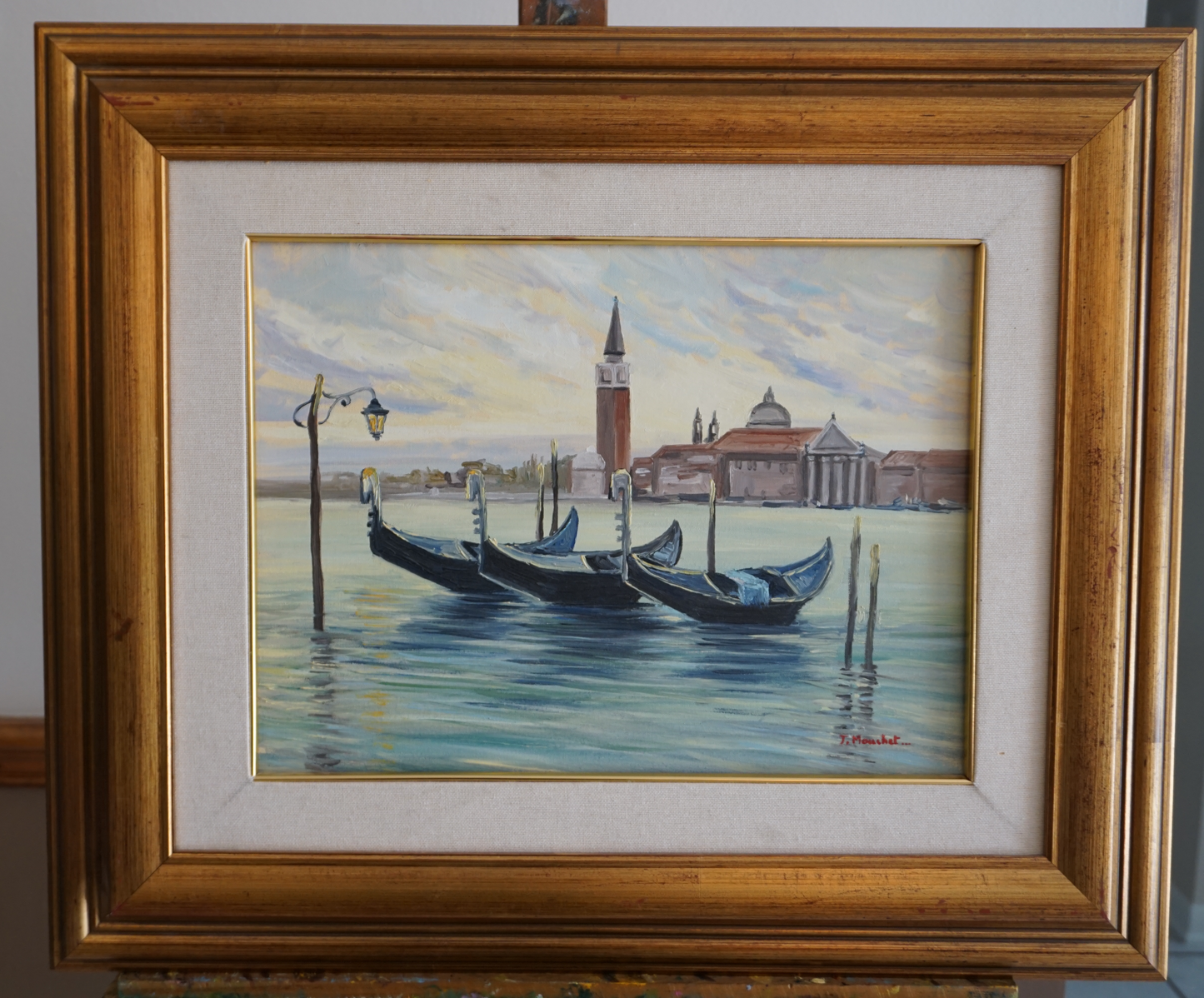 Original oil painting titled 'Piazza San Marco', measuring 30 cm x 40 cm. This captivating scene captures Venice at sunset, featuring gondolas in the foreground and the historic Piazza San Marco in the backdrop, illuminated by the golden light of the setting sun. The artwork, framed and accompanied by a certificate of authenticity, invites viewers to feel the romance and charm of Venice, as the gondolas and plaza share whispers of timeless tales.